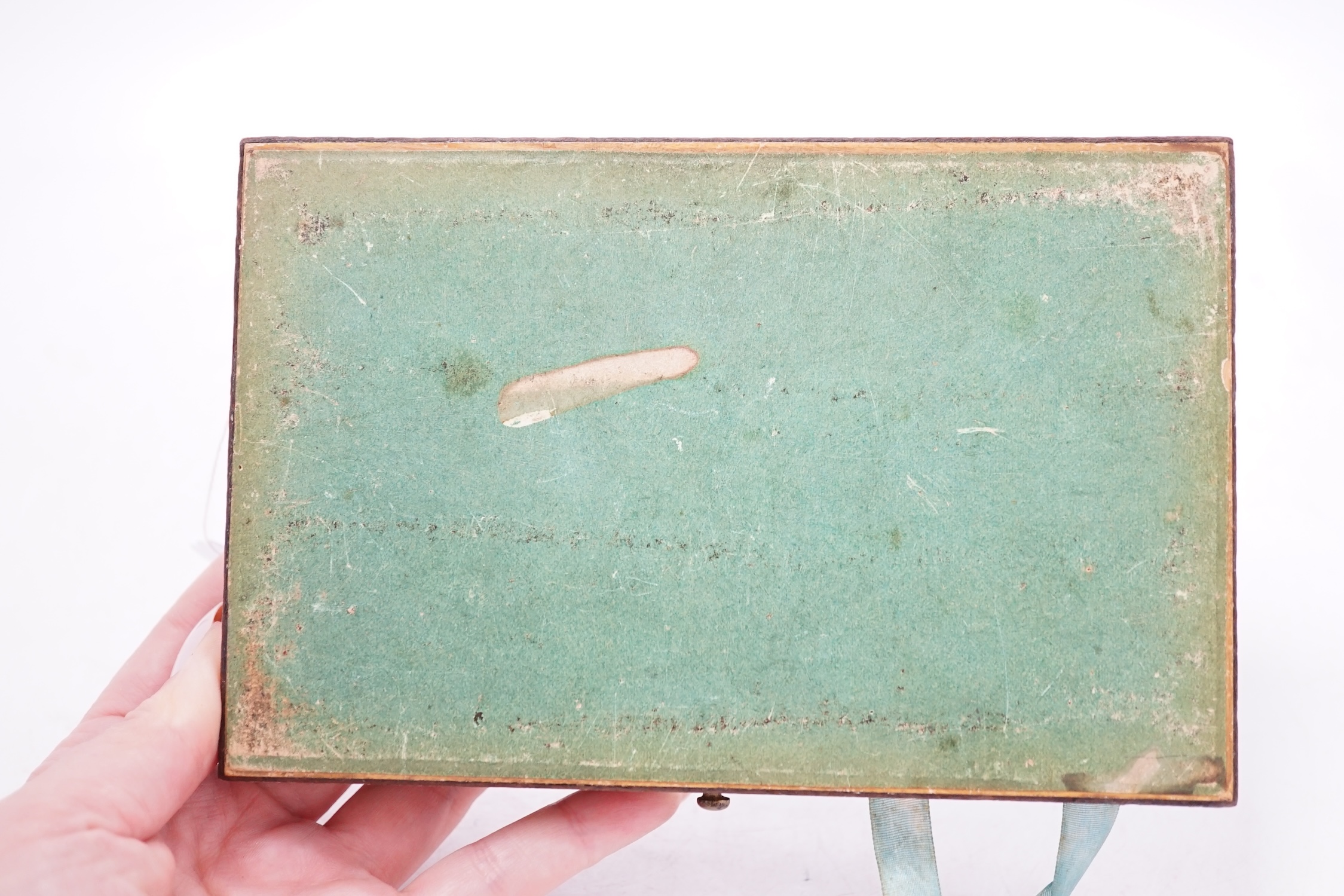 An early 19th century penwork box with country scene decoration to top cover and monkey and butterfly decoration to interior sectional cover, 17cm wide. Condition - box cover worn, interior of box fair